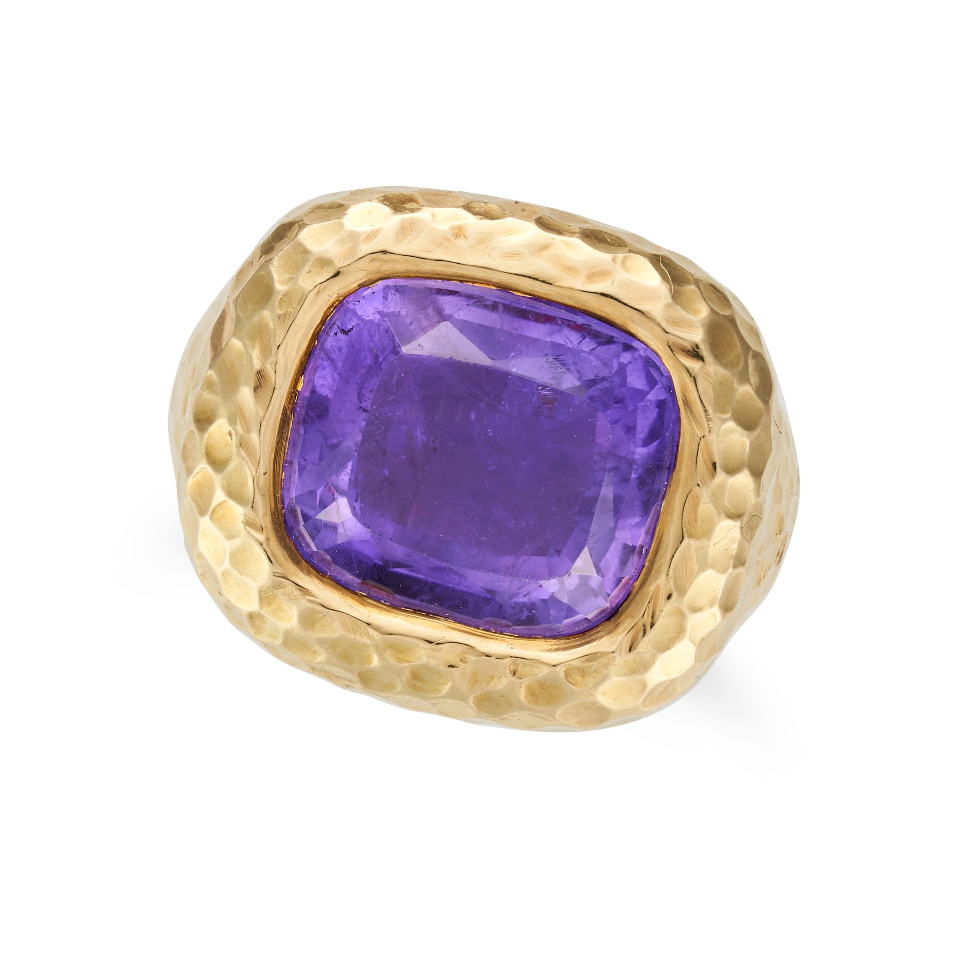 DAVID WEBB, AN AMETHYST RING set with a cushion cut amethyst in a hammered gold mount, sizing ban...