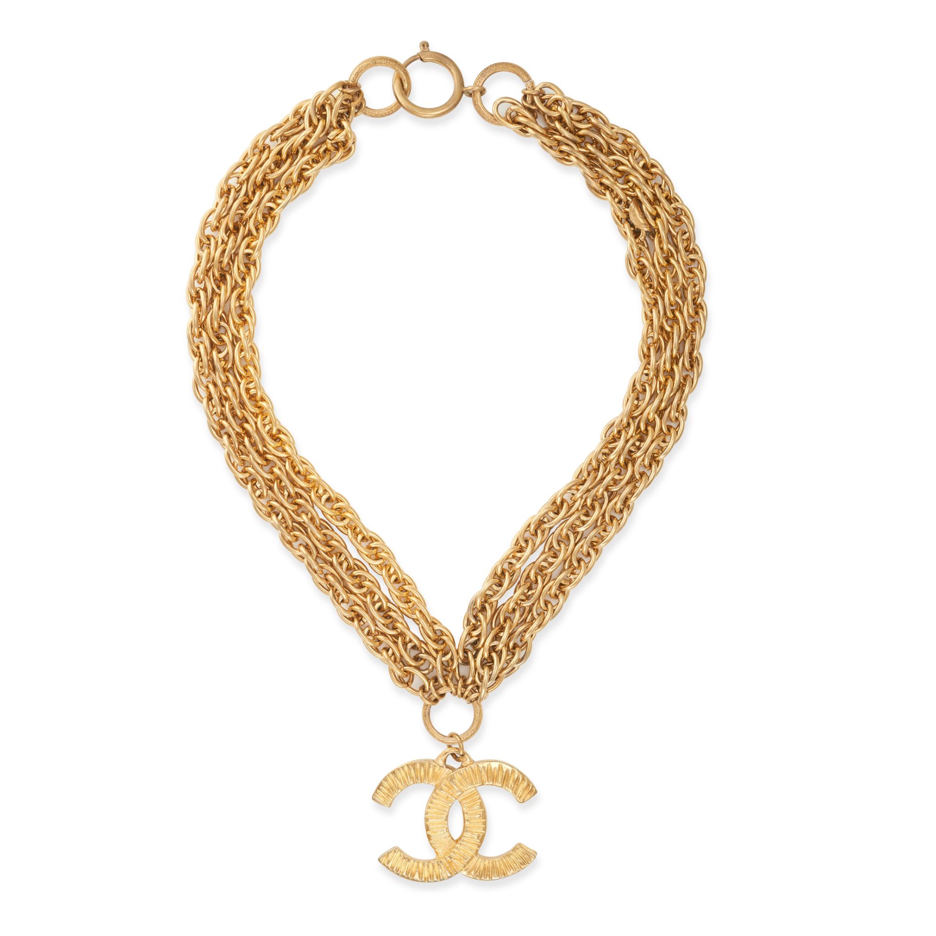 CHANEL, A VINTAGE PENDANT AND CHAIN comprising a textured pendant with interlocking CC motifs, su...