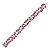 A RUBY AND DIAMOND BRACELET set throughout with oval cut rubies accented by round brilliant cut d...