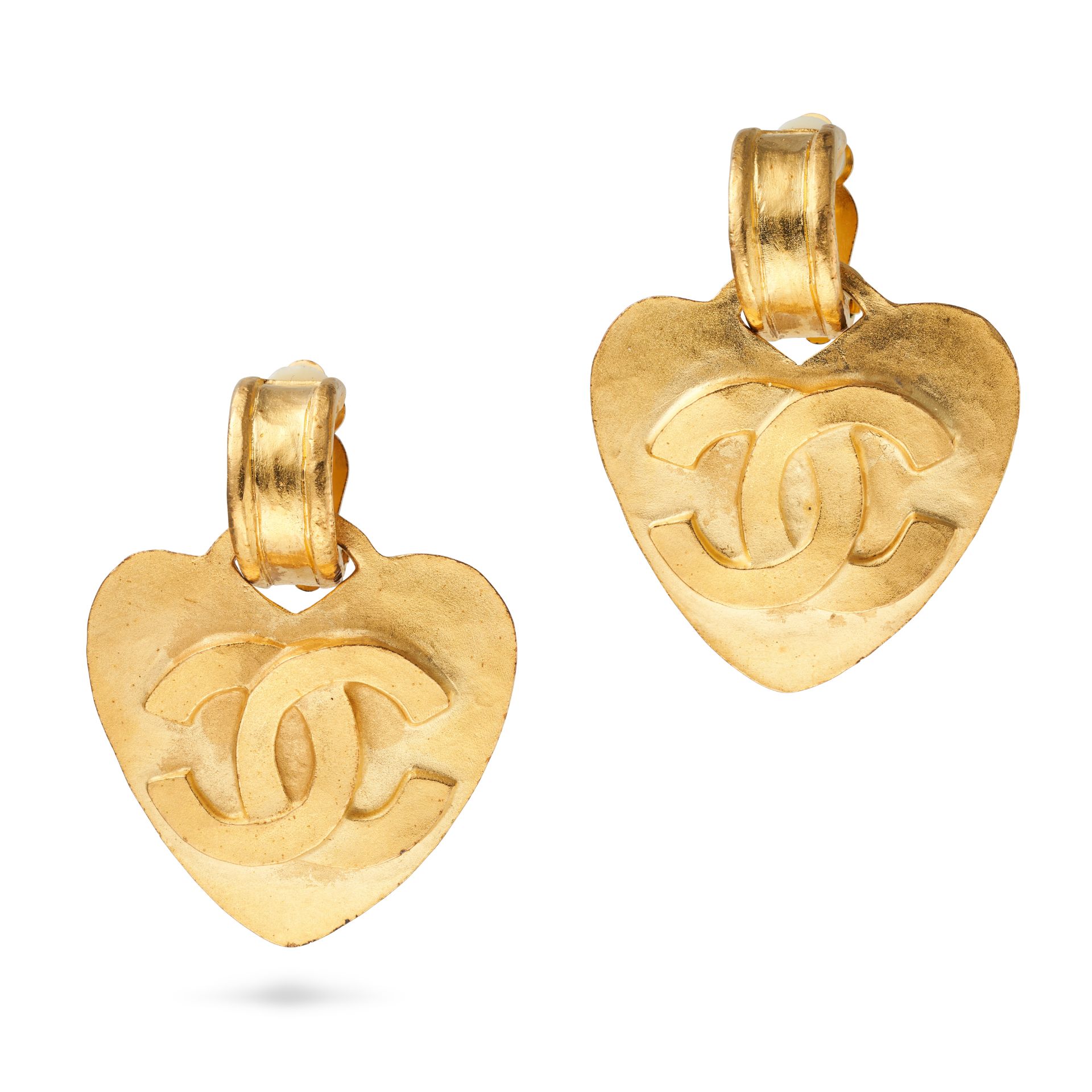CHANEL, A PAIR OF VINTAGE CLIP EARRINGS each comprising a heart shape charm with interlocking CC ...