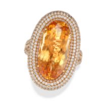 A TOPAZ AND DIAMOND RING set with an oval cut topaz of 15.52 carats in a border of pave set round...