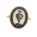 AN ANTIQUE GEORGIAN ENAMEL MOURNING RING the oval face painted to depict an urn, relieved in whit...