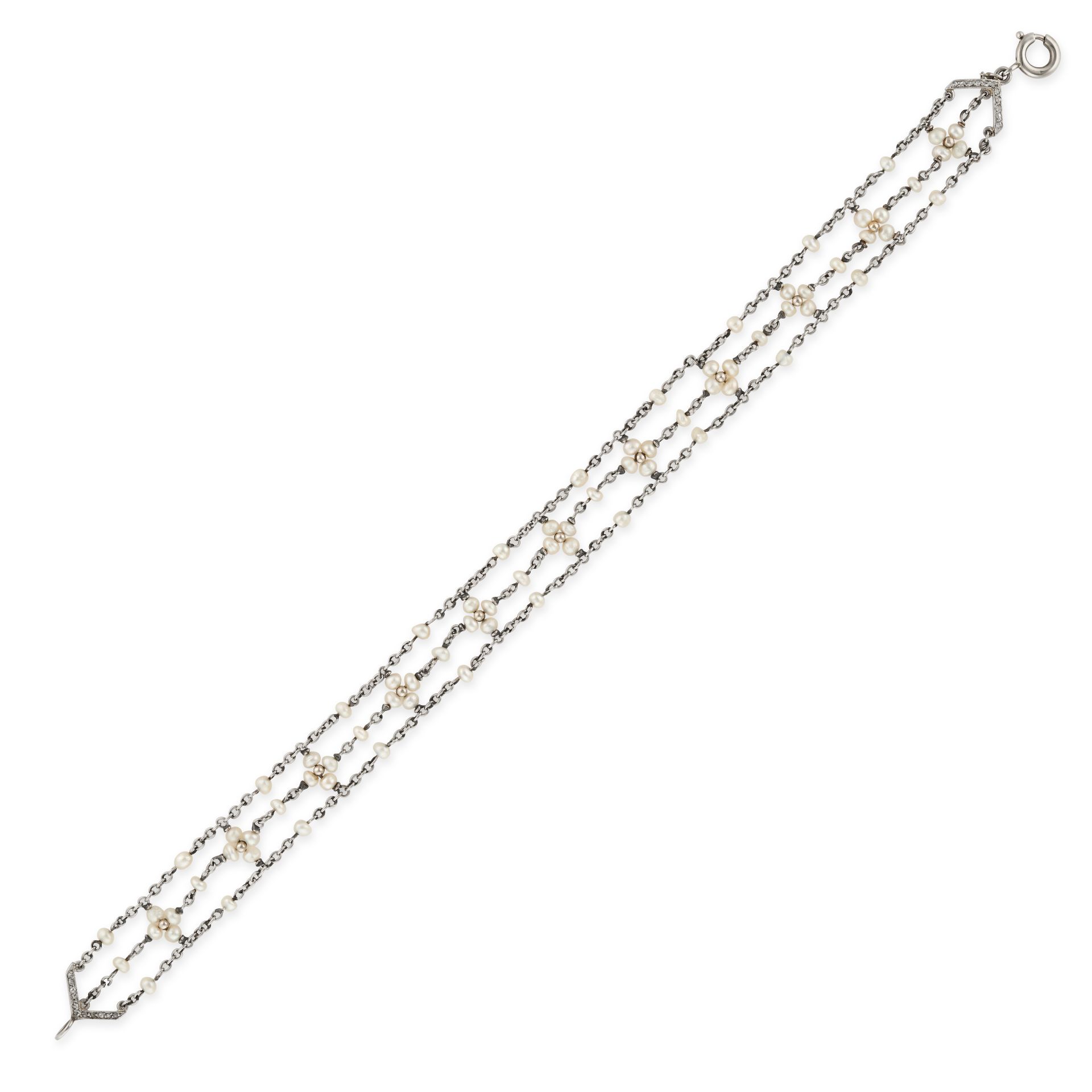 A PEARL AND DIAMOND BRACELET in white gold, comprising three rows of trace chain set with seed pe...