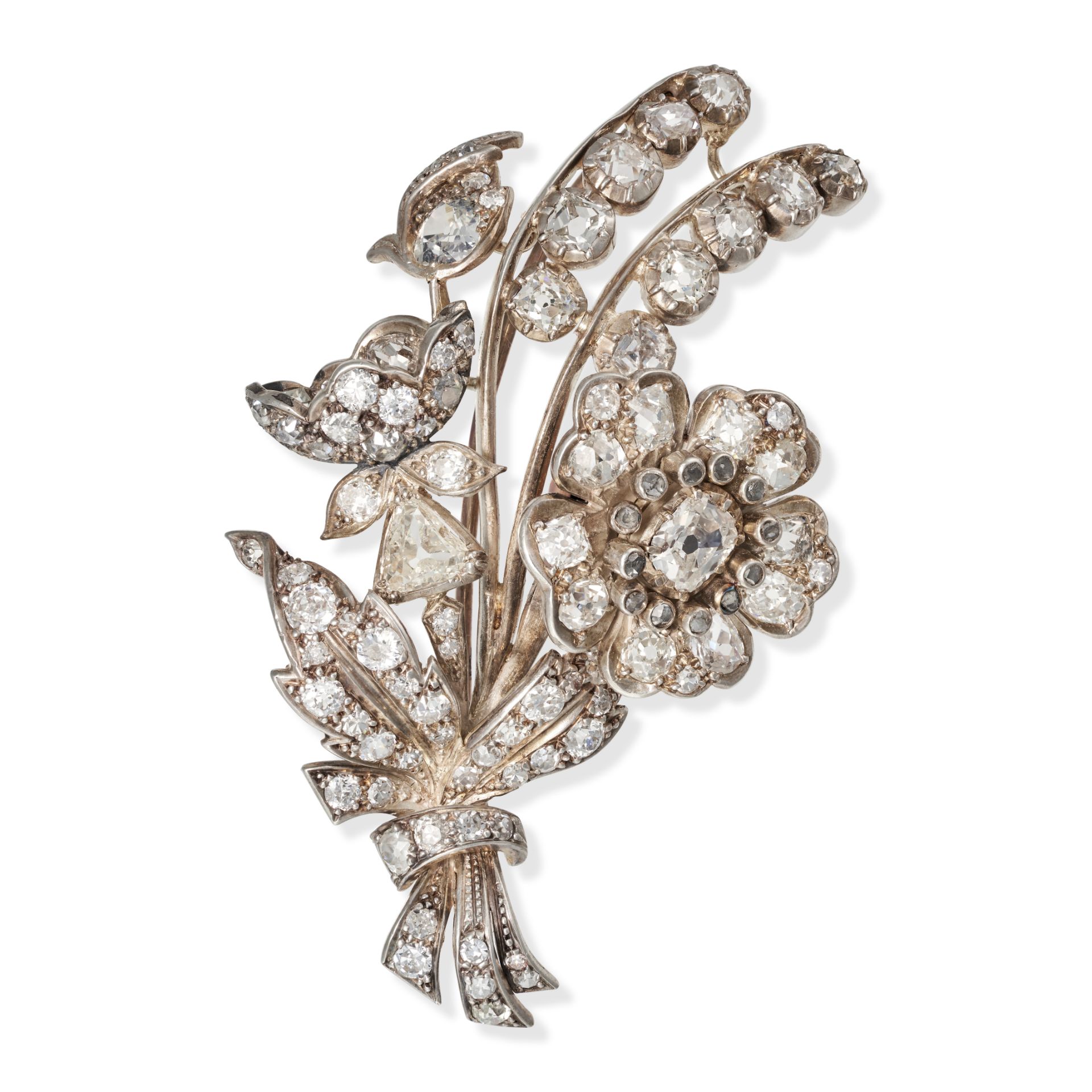 AN ANTIQUE DIAMOND EN TREMBLANT FLORAL SPRAY BROOCH in yellow gold and silver, designed as a flor...