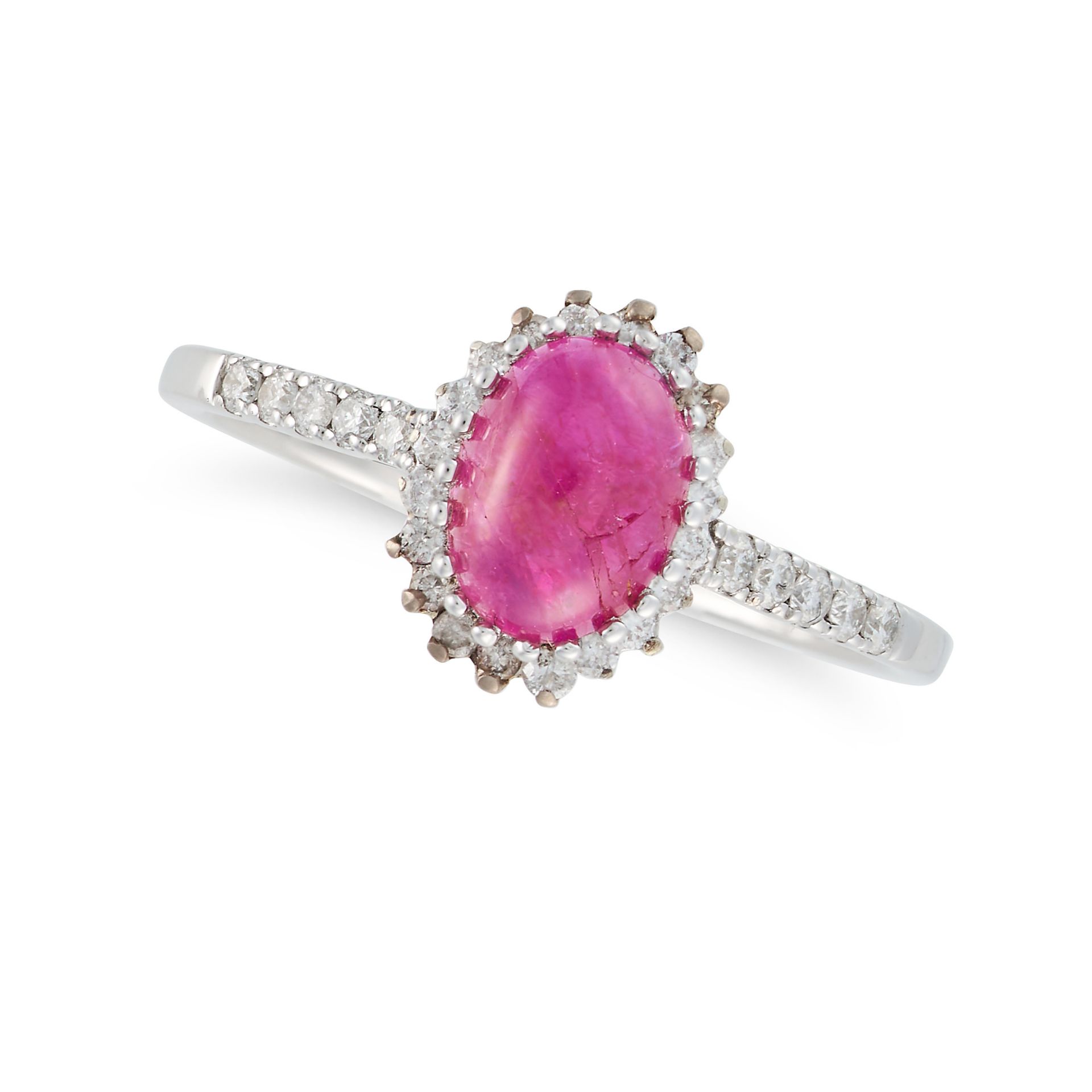 NO RESERVE - A RUBY AND DIAMOND RING in 9ct white gold, set with an oval cabochon ruby in a borde...