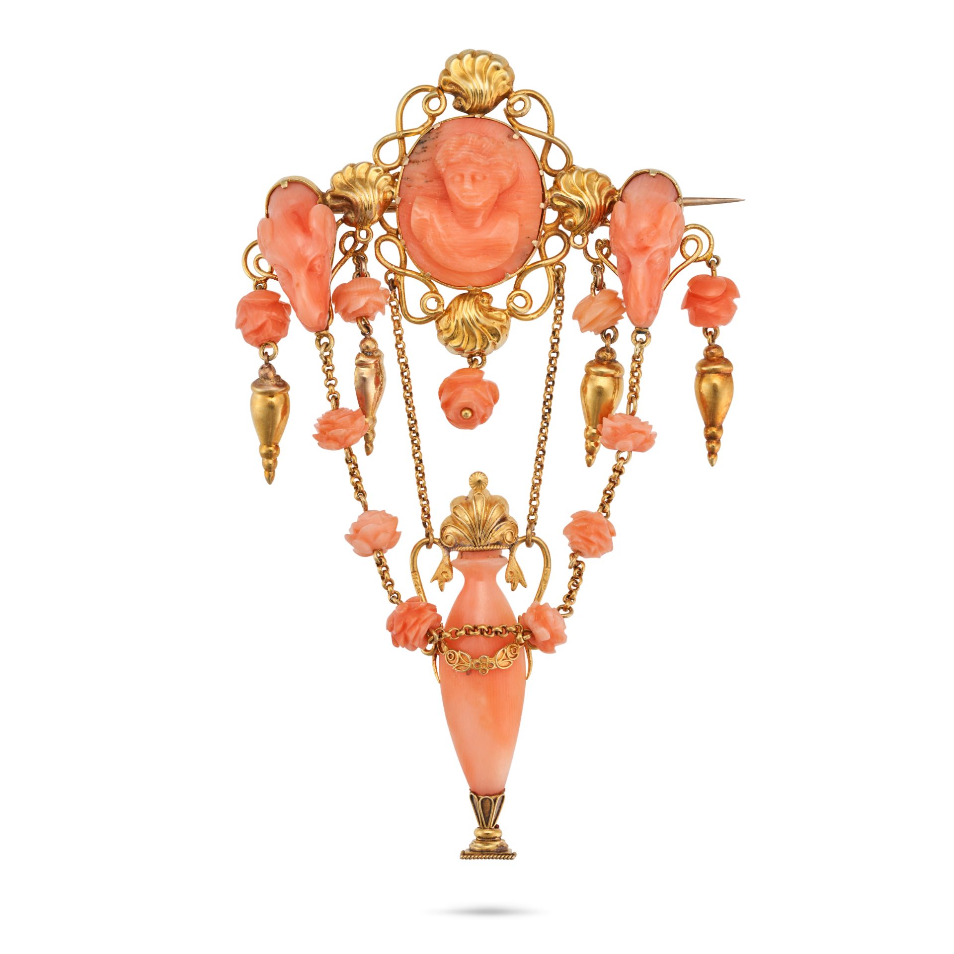 AN ANTIQUE CORAL BROOCH the openwork brooch set with three coral cameos carved to depict the bust...