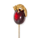 AN ANTIQUE GARNET FOX STICK PIN in 18ct yellow gold, set with a cabochon garnet with an applied f...