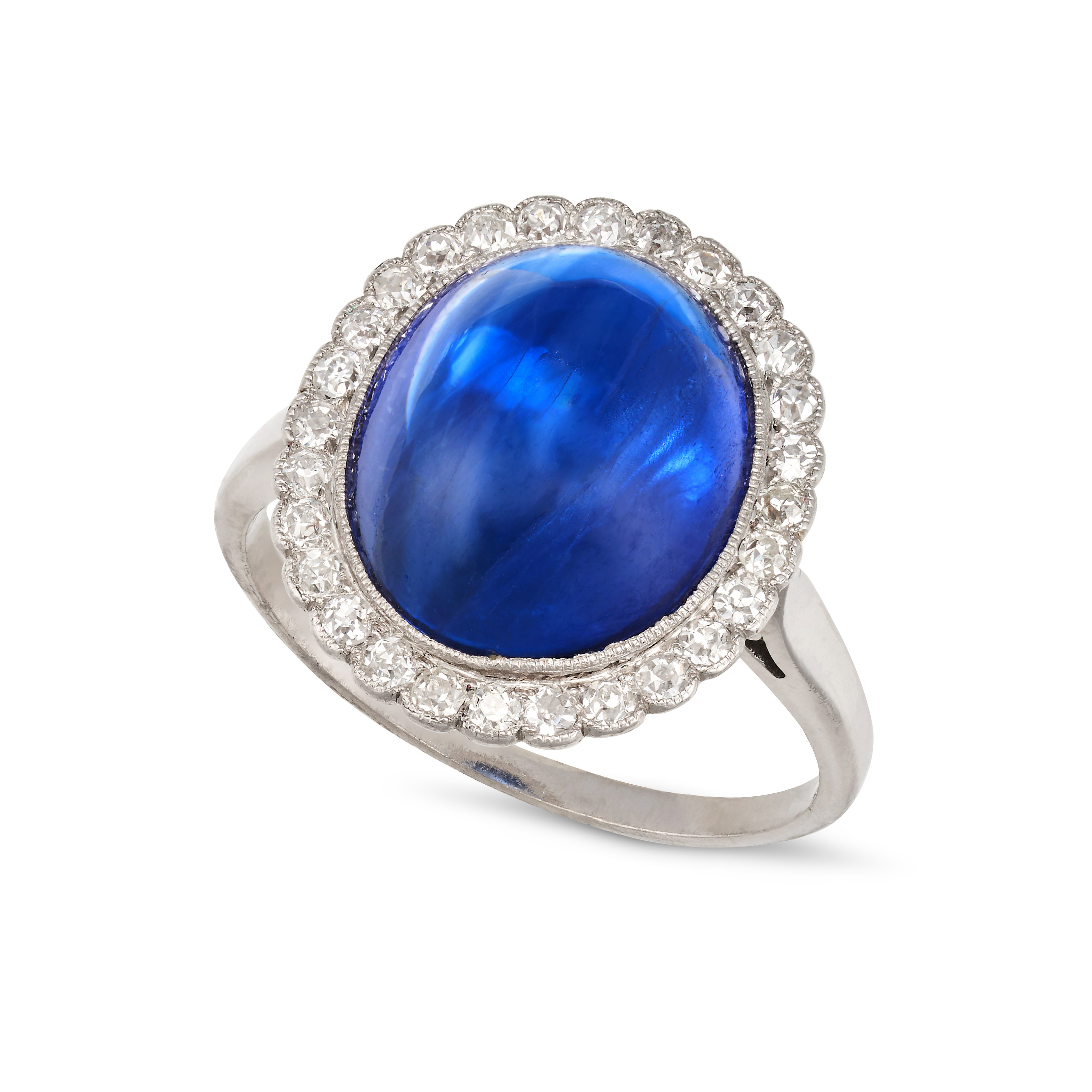 A FINE BURMA NO HEAT SAPPHIRE AND DIAMOND RING set with an oval cabochon blue sapphire of 12.32 c...