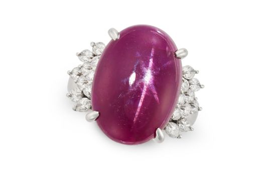 A BURMA NO HEAT STAR RUBY AND DIAMOND RING set with an oval cabochon star ruby of 13.61 carats, a...