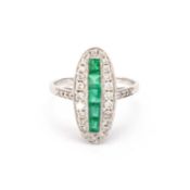 AN 18 CARAT WHITE GOLD EMERALD AND DIAMOND ART DECO STYLE OVAL RING