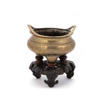 A CHINESE BRONZE TRIPOD CENSER