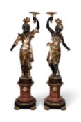 A PAIR OF NORTH ITALIAN EBONISED, GILT AND POLYCHROME-DECORATED BLACKAMOOR TORCHÈRES