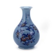 AN UNDERGLAZE BLUE AND RED-DECORATED BLUE-GLAZED PEAR-SHAPED VASE