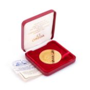 A THE TOWER MINT COMMEMORATIVE GOLD PLATED OMEGA MEDALLION
