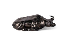 A CHINESE GREY-BLACK CERAMIC MODEL OF A RECUMBENT WATER BUFFALO OR OTHER BOVINE, 19TH CENTURY