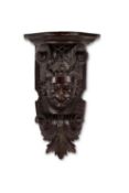 A 19TH CENTURY CARVED AND SCUMBLED PINE WALL BRACKET