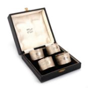 A SET OF FOUR GEORGE VI SILVER NAPKIN RINGS