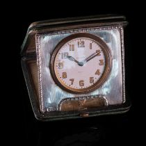 A SILVER AND LEATHER TRAVEL CLOCK