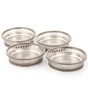 A SET OF FOUR FRENCH SILVER COASTERS