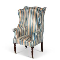 AN EARLY 19TH CENTURY MAHOGANY AND UPHOLSTERED WING-BACK ARMCHAIR