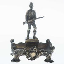 AN EDWARDIAN SILVER-GILT FIGURE OF A BOER WAR SOLDIER