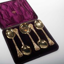 A CASED SET OF FOUR VICTORIAN SILVER-GILT SPOONS AND A SIFTING LADLE