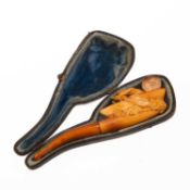 AN UNUSUAL 19TH CENTURY CARVED MEERSCHAUM AND AMBER ROWING BOAT PIPE