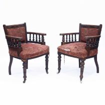 A PAIR OF VICTORIAN WALNUT LIBRARY CHAIRS, IN THE MANNER OF LAMB OF MANCHESTER