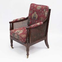 AN EARLY 19TH CENTURY MAHOGANY BERGÈRE ARMCHAIR