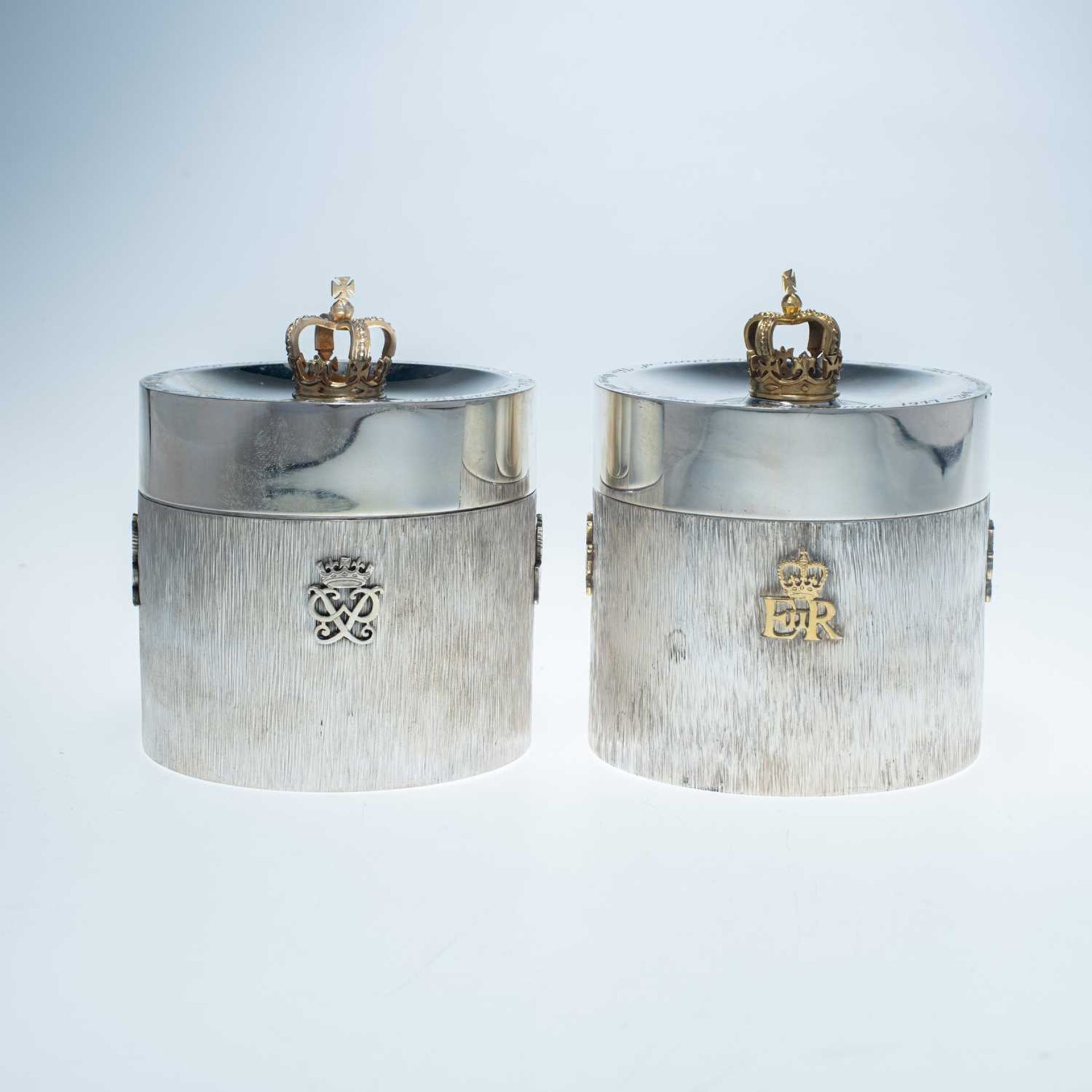 A NEAR PAIR OF ELIZABETH II LIMITED EDITION ROYAL COMMEMORATIVE PARCEL-GILT SILVER CANISTERS