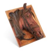 A CARVED WOODEN PANEL DEPICTING A HORSE