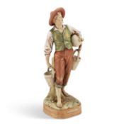 A ROYAL DUX FIGURE OF A WATER CARRIER