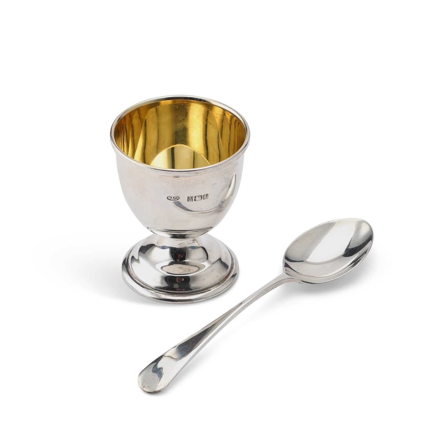 AN ELIZABETH II SILVER EGG CUP AND SPOON