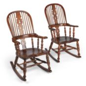 A PAIR OF 19TH CENTURY ELM AND OAK LADIES AND GENTLEMENS BROAD-ARM WINDSOR ROCKING CHAIRS