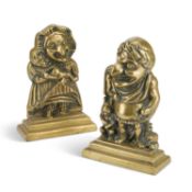 A PAIR OF VICTORIAN BRASS PUNCH AND JUDY DOOR STOPS