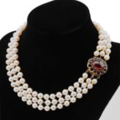 A TRIPLE STRAND CULTURED PEARL NECKLACE