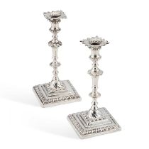 A PAIR OF GEORGE III CAST SILVER TAPERSTICKS
