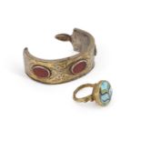 A PHOENICIAN STYLE RING AND A GILT-METAL BANGLE