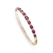 AN 18 CARAT GOLD RUBY AND DIAMOND BANGLE