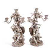 A PAIR OF VICTORIAN SILVERED-BRONZE 'EXOTIC' THREE-LIGHT FIGURAL CANDELABRA