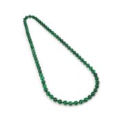A STRING OF JADEITE BEADS