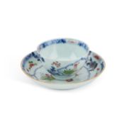 AN 18TH CENTURY CHINESE FAMILLE ROSE TEA BOWL AND SAUCER