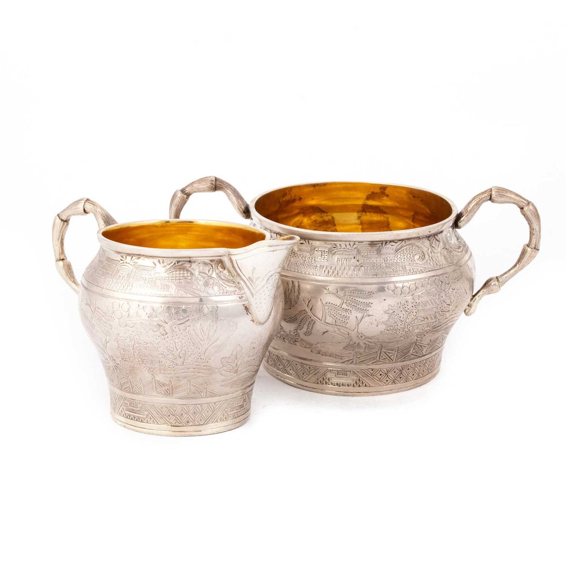 A VICTORIAN SILVER CHINOISERIE CREAM JUG AND TWO-HANDLED SUGAR BOWL