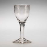 AN ETCHED WINE GLASS