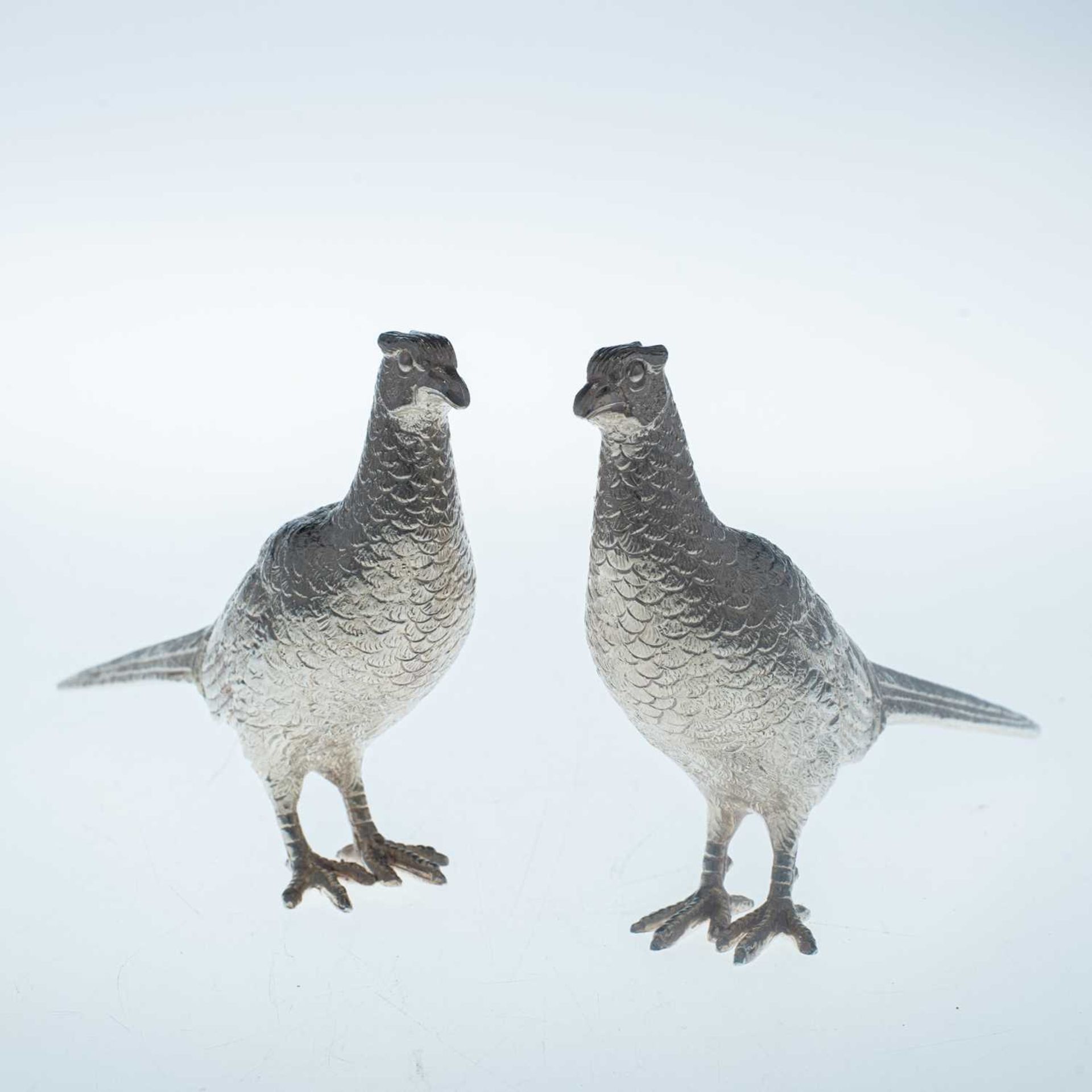 A PAIR OF ELIZABETH II SILVER MODELS OF PHEASANTS