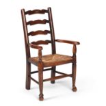 A EARLY 20TH CENTURY OAK RUSH-SEATED CHILD'S CHAIR