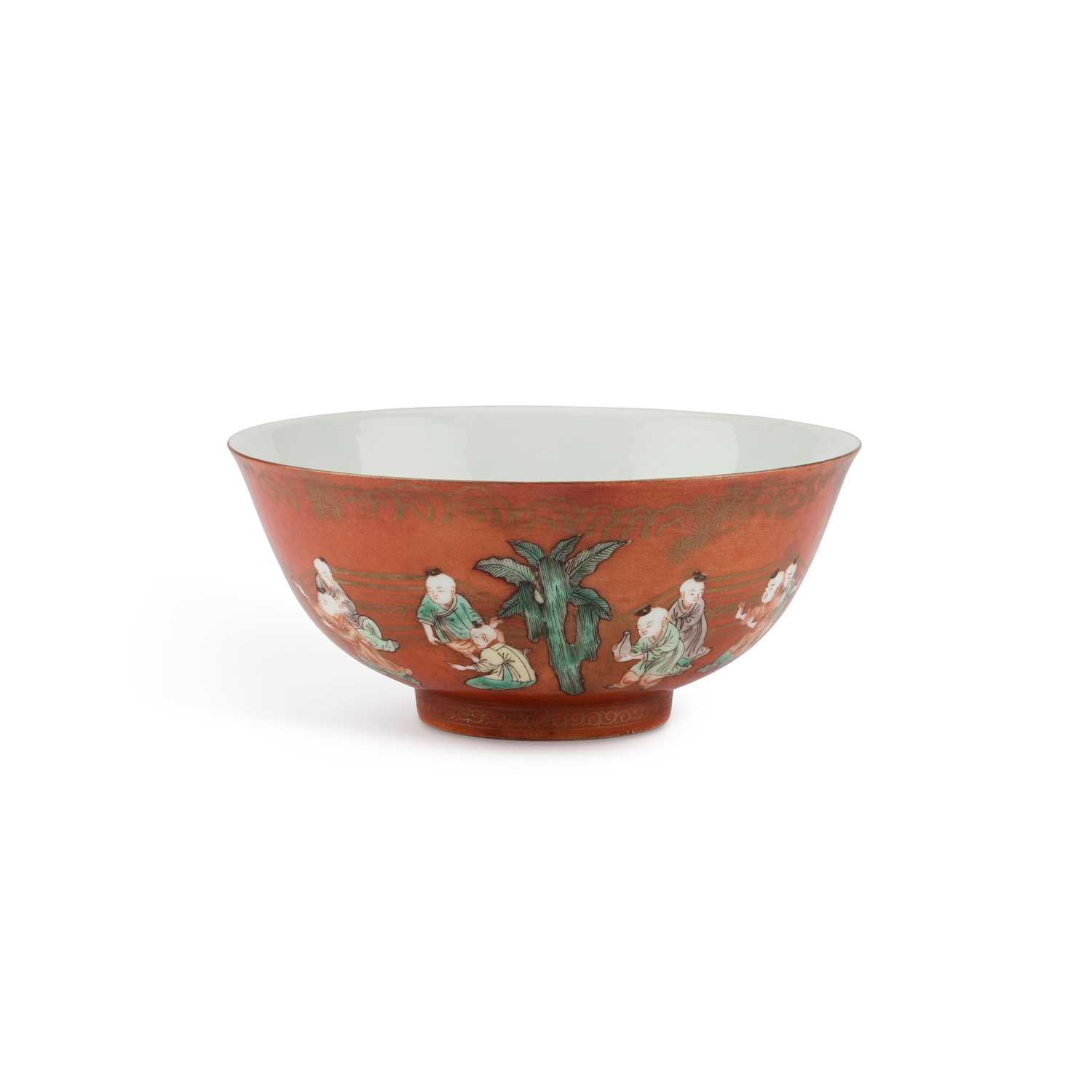 A CHINESE CORAL-GROUND FAMILLE VERTE 'BOYS' BOWL