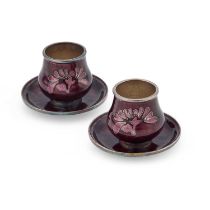 A PAIR OF SILVER AND ENAMEL CUPS AND SAUCERS