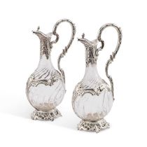 A PAIR OF ROCOCO REVIVAL FRENCH SILVER-MOUNTED GLASS CLARET JUGS