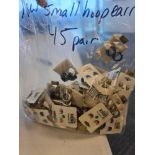 large box of miscellaneous charms jewelry and bag of small hoop earrings